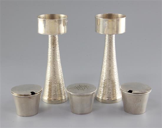 A pair of 1970s silver candle holders and a three piece silver condiment set by Graham Watling of Lacock, gross 17 oz.